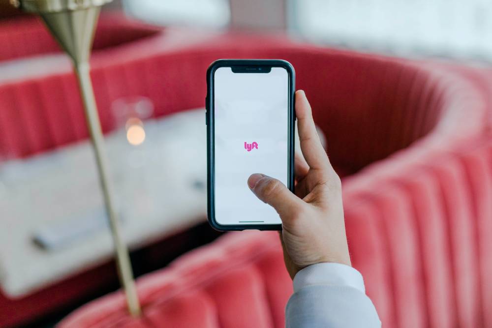 mano che tiene uno smartphone con app dating sullo sfondo