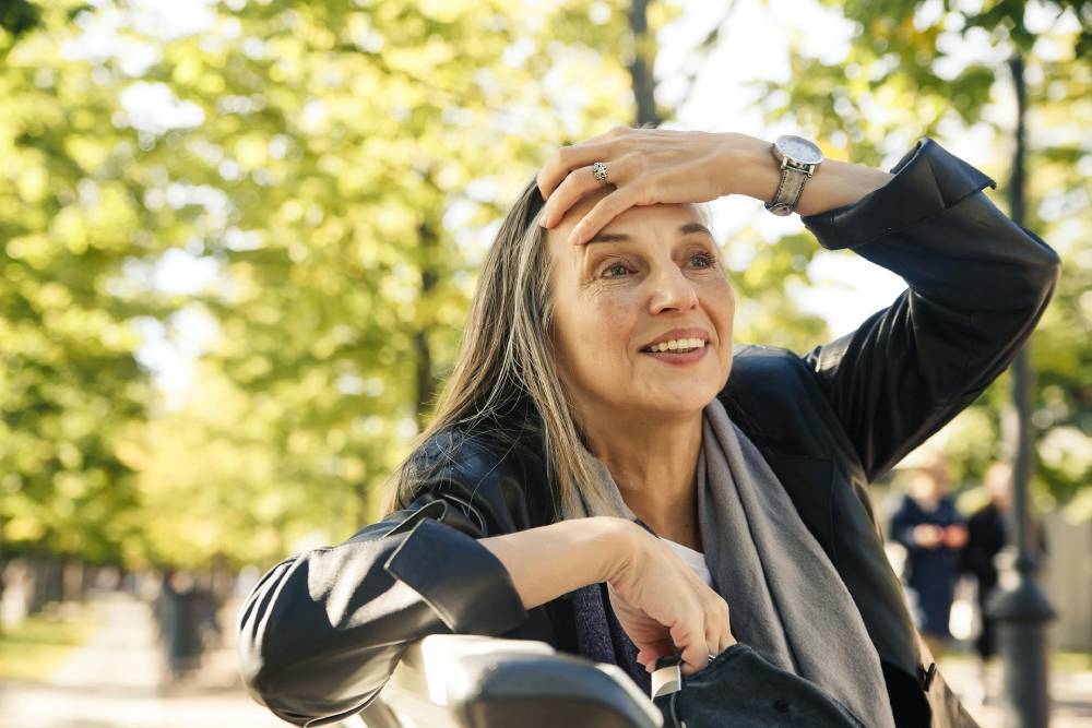 donna di 50 anni che si tiene la fronte